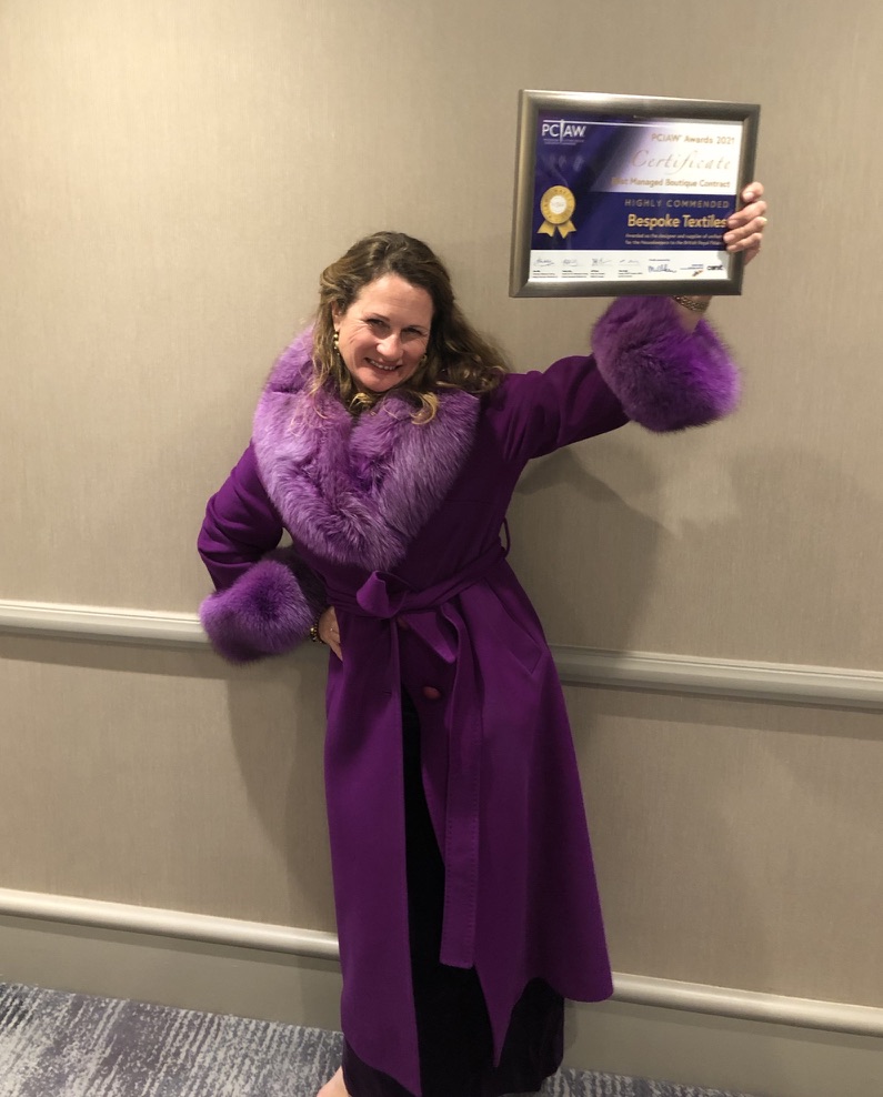 Katie holding a PCIAW Highly Commended certificate for Bespoke Textiles
